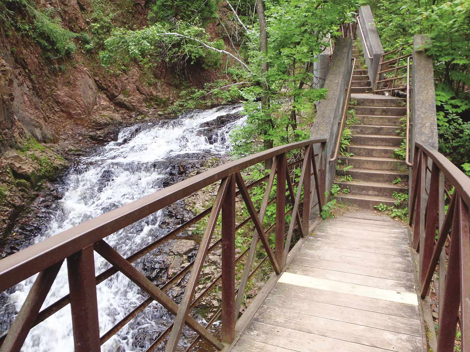 Waterfall in the park next to the wooden bridge