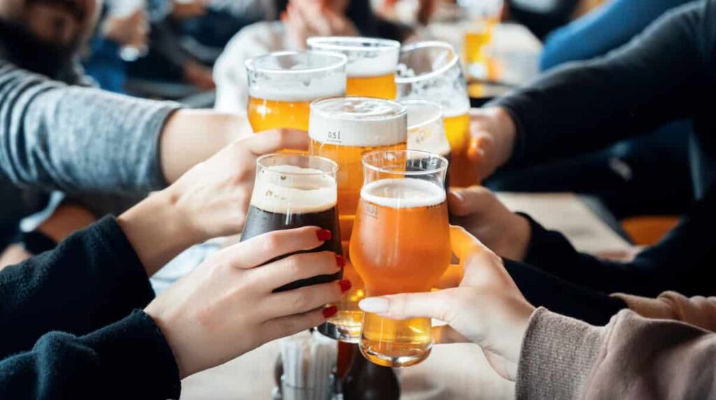 A group of friends toasting with various types of beer